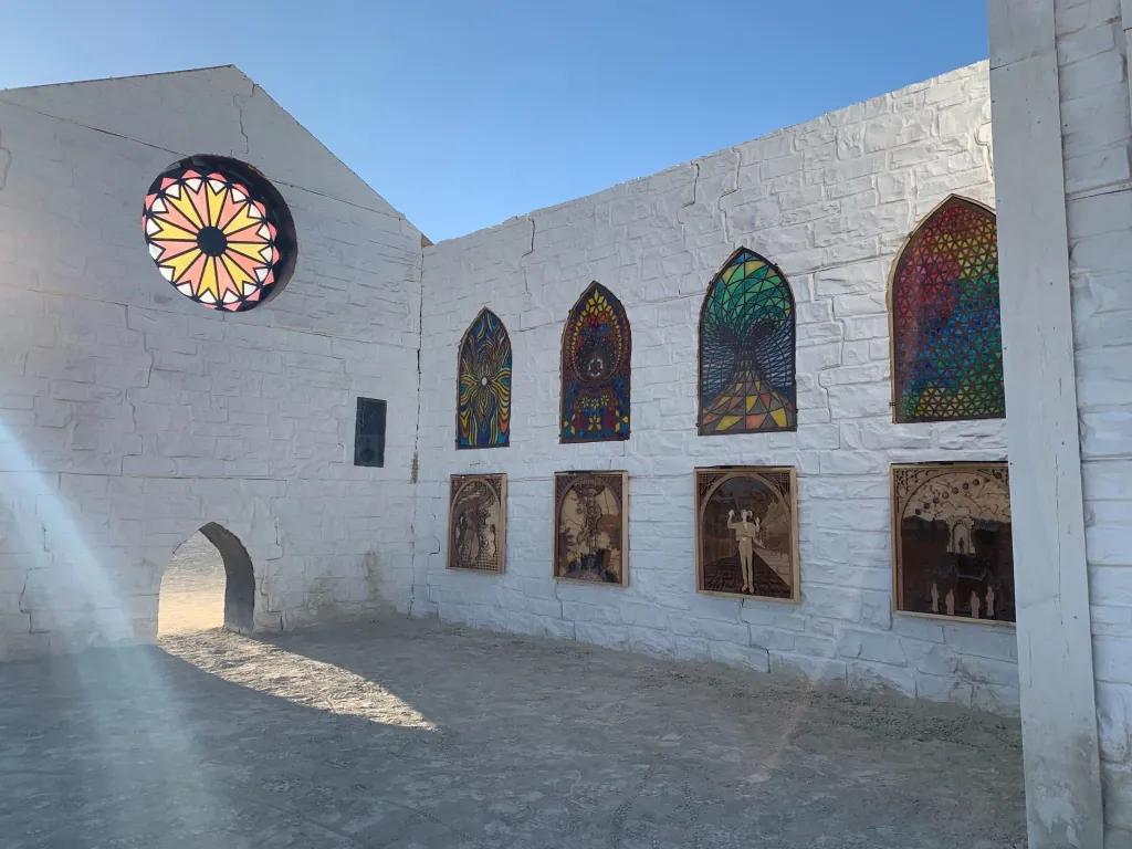 White temple structure with arched stained glass windows